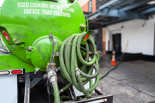 a grease trap being pumped by a sanitation technician in Alhambra